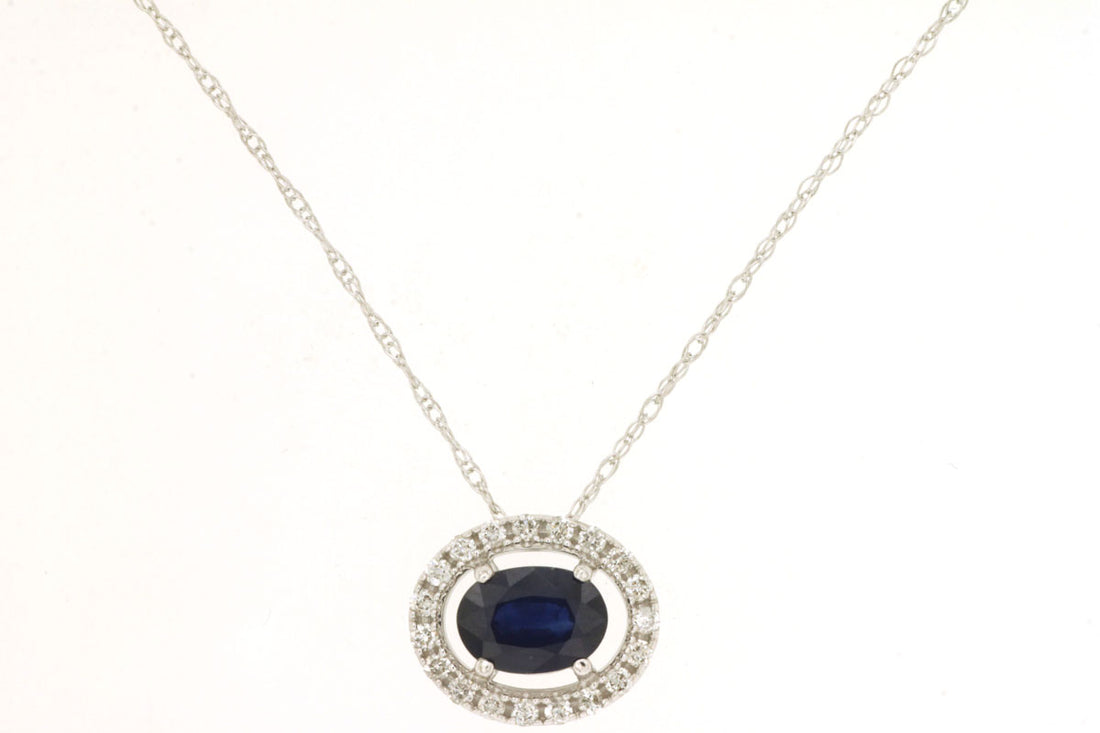 Oval Blue Sapphire Halo Necklace in 14 Karat White Gold - East To West Design (0.65 ct)